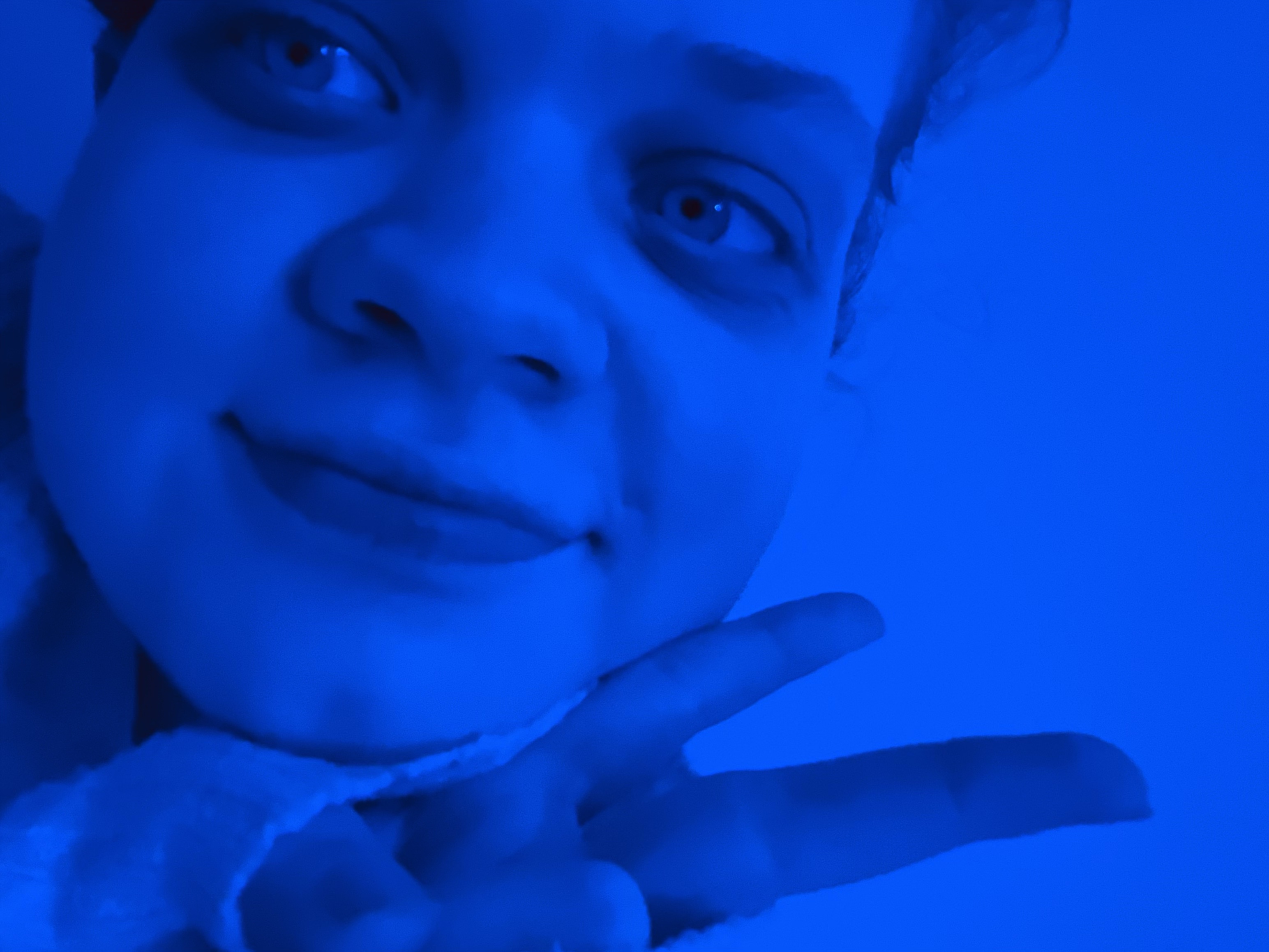 Tig makes the peace sign.