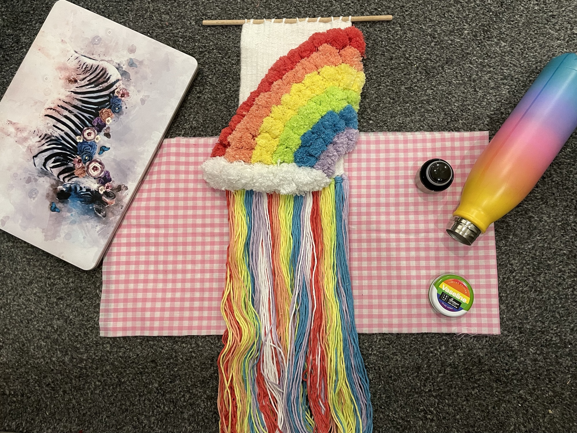 a rainbow pom-pom picture weave 